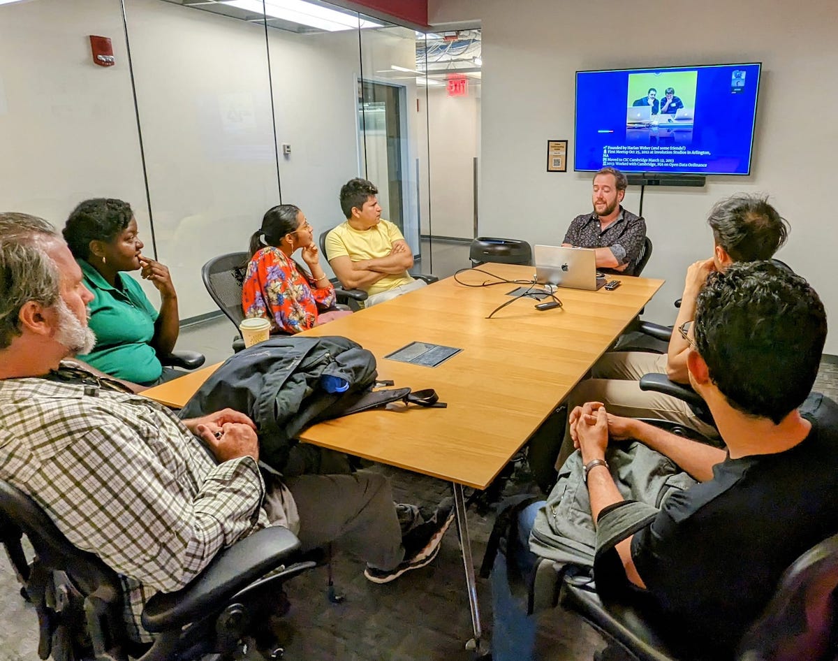 Code for Boston meeting around a conference table.